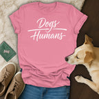 Pink t-shirt with white text "Dogs Humans" and a dog.