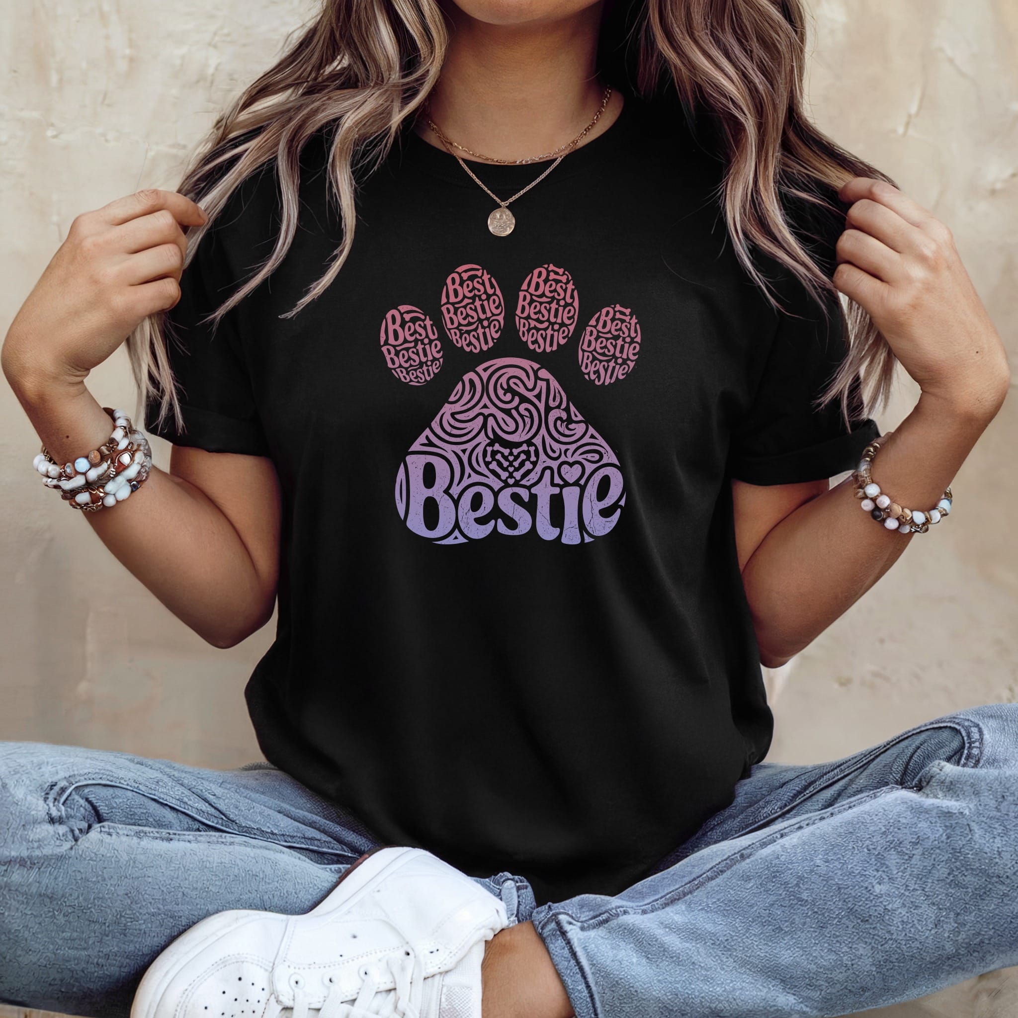 Black t-shirt with a pink and purple paw print design saying "Bestie Bestie Bestie".