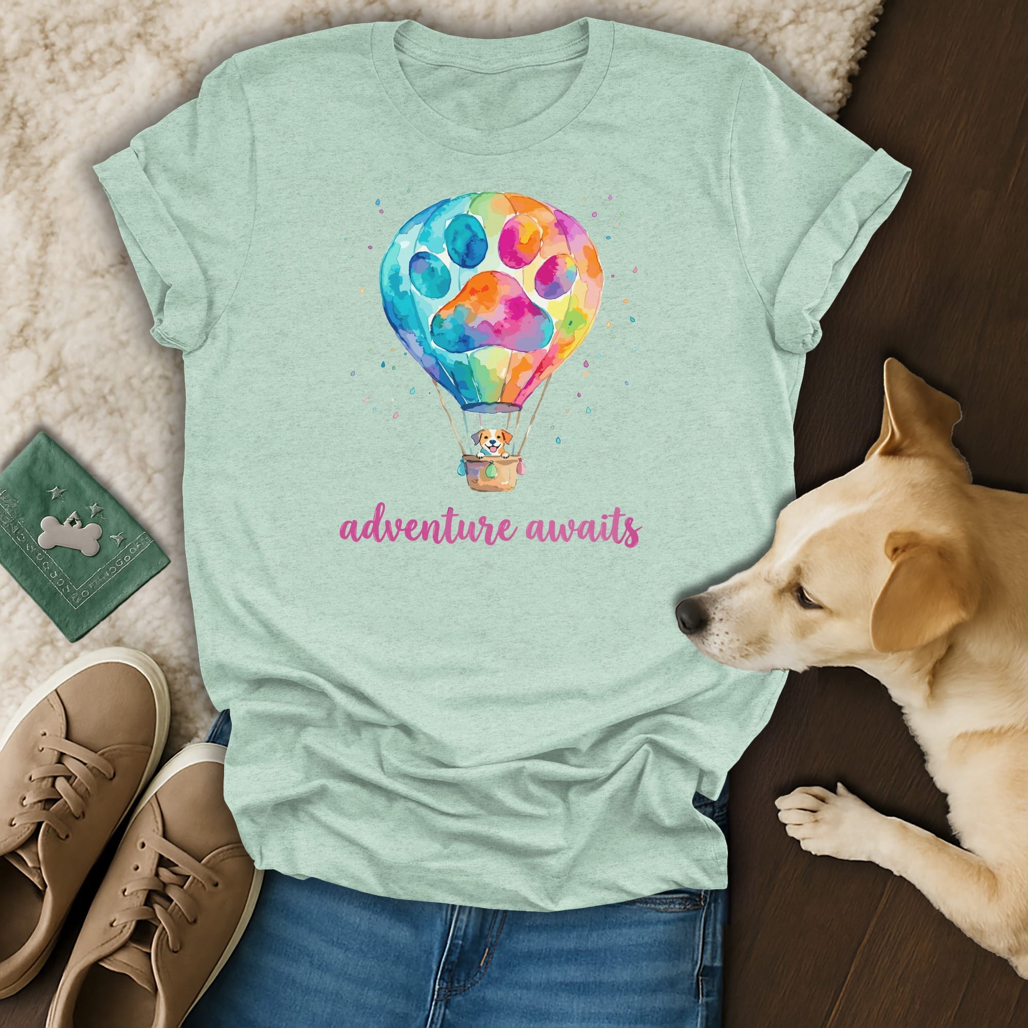 T-shirt with colorful hot air balloon featuring a dog and paw print; "adventure awaits."