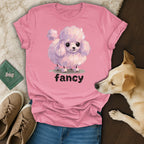 Pink t-shirt with a fluffy white poodle illustration and "fancy" text.