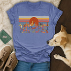 T-shirt with vintage sunset and diverse dog illustrations.