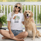 Woman wearing white t-shirt with dogs and goose graphic, "dog, dog, GOOSE" text.