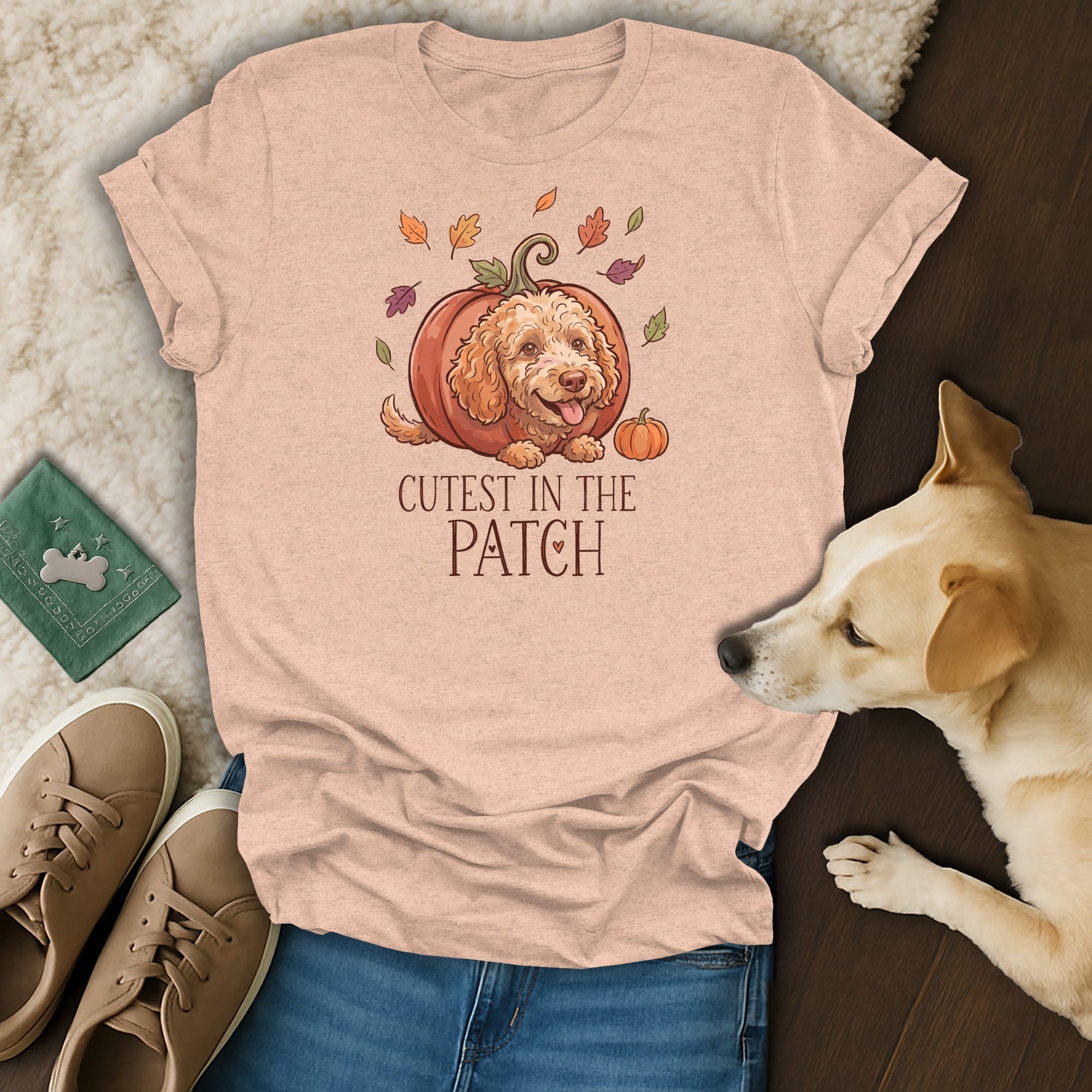 Peach t-shirt with a doodle dog in a pumpkin and "Cutest in the Patch" text.
