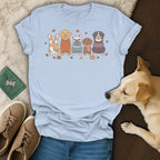 Light blue t-shirt with a print of five dogs in sweaters and fall accents.