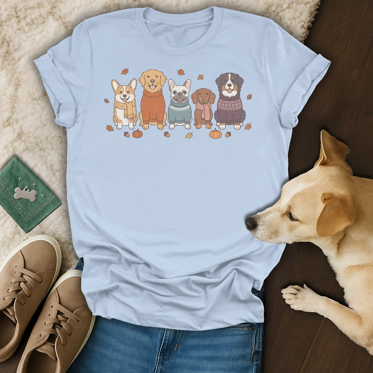 Light blue t-shirt with a print of five dogs in sweaters and fall accents.