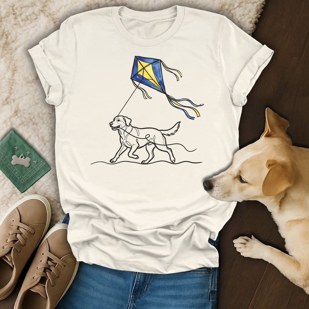 White t-shirt with a yellow and blue kite and dog line drawing.