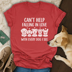 Red t-shirt with white text "CAN'T HELP FALLING IN LOVE WITH EVERY DOG I SEE" and dog illustrations.