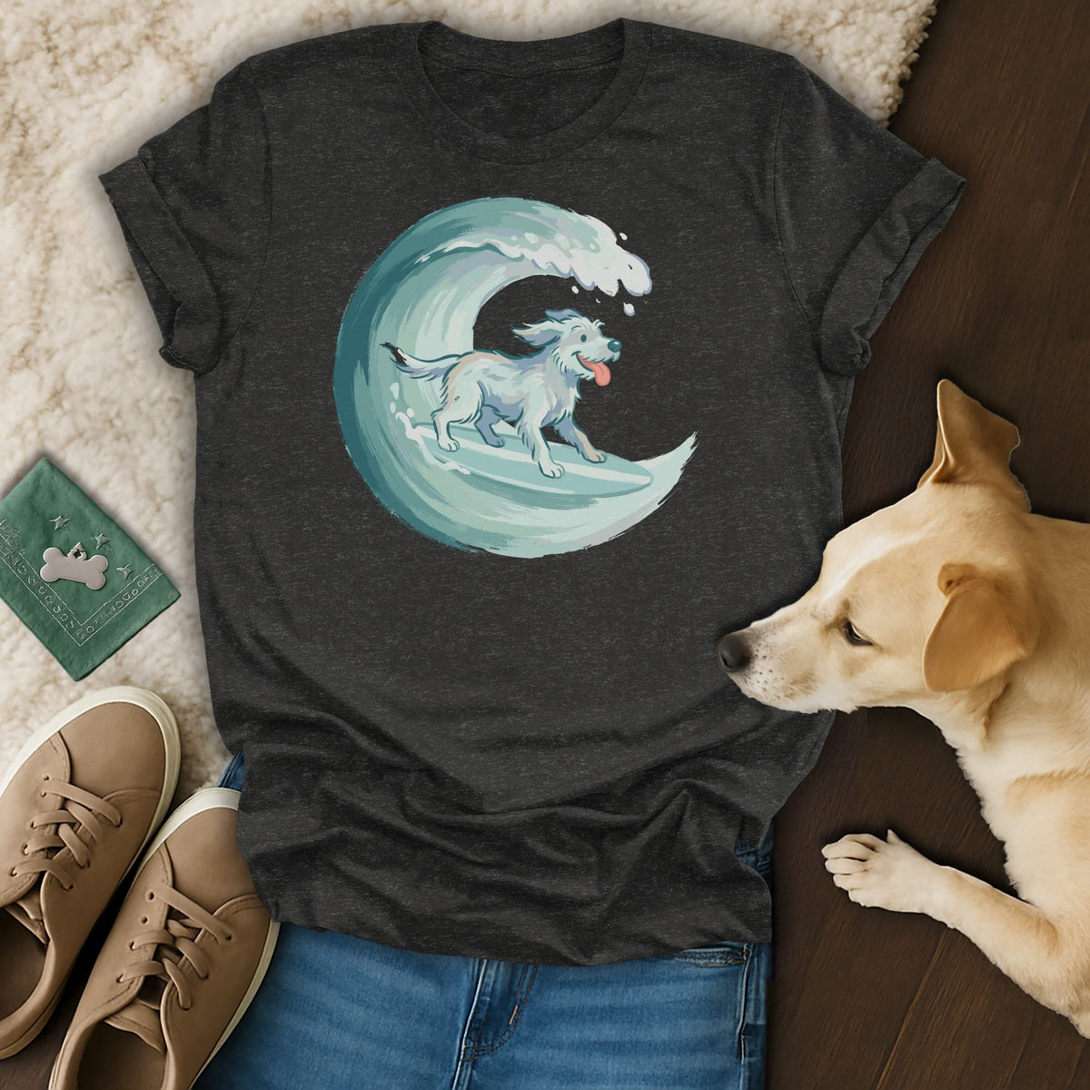 Dark grey t-shirt with illustration of a white dog surfing a wave.