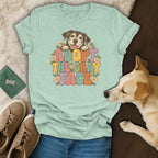 Light green t-shirt with retro "Adopt the Gray Face" dog graphic surrounded by daisies.