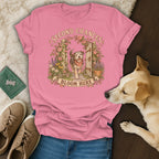A pink t-shirt with a graphic of a dog, flowers, and the text Second Chances Bloom Here.