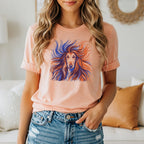 Peach t-shirt with a graphic of a long-haired dog's face in blue and orange.