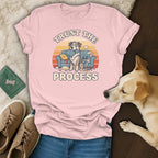 Pink t-shirt with "Trust the Process" text and cartoon dog on a couch.