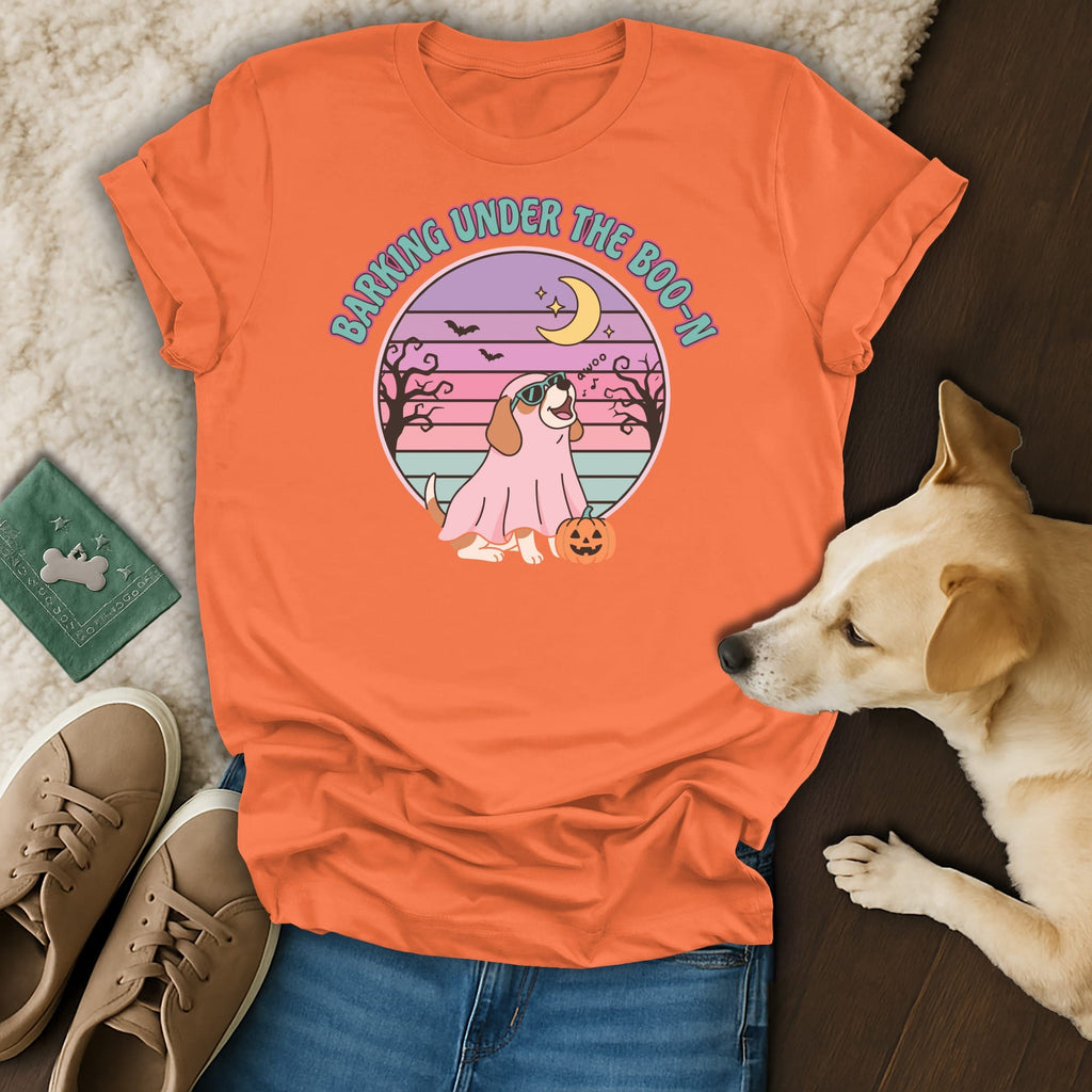 Orange t-shirt with a dog wearing a ghost costume and "Barking Under the Boo-N" text.