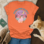 Orange t-shirt with a dog wearing a ghost costume and "Barking Under the Boo-N" text.