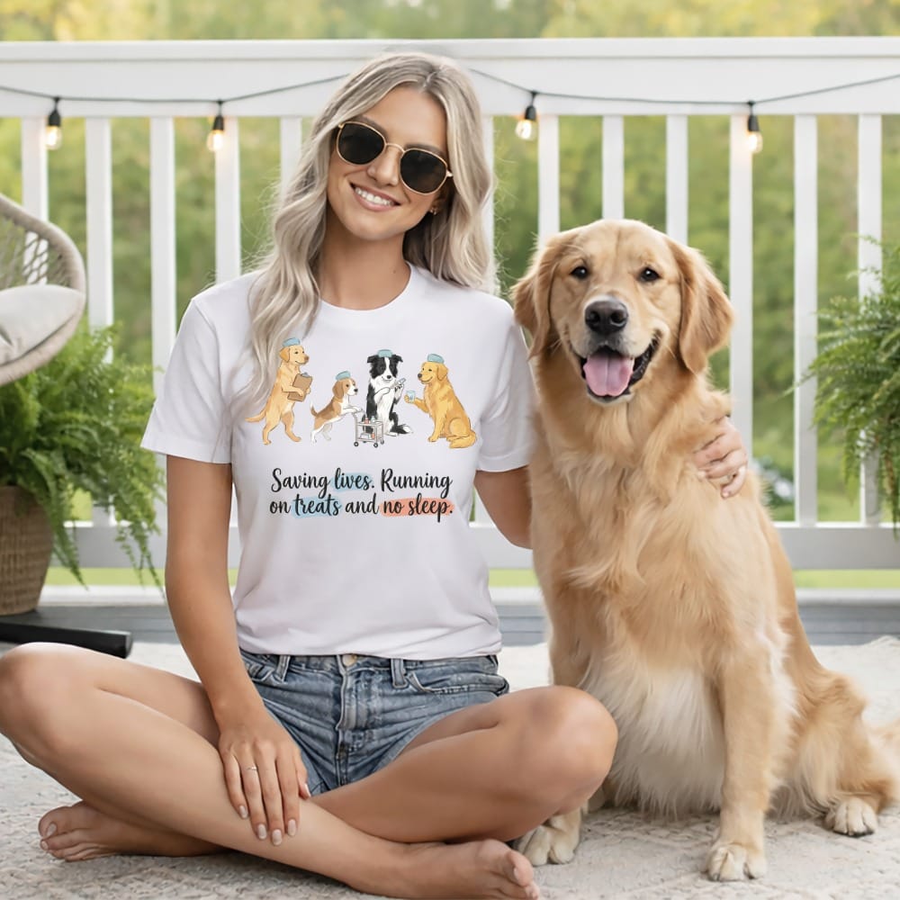 Woman with golden retriever wearing a t-shirt with cartoon dogs and text.