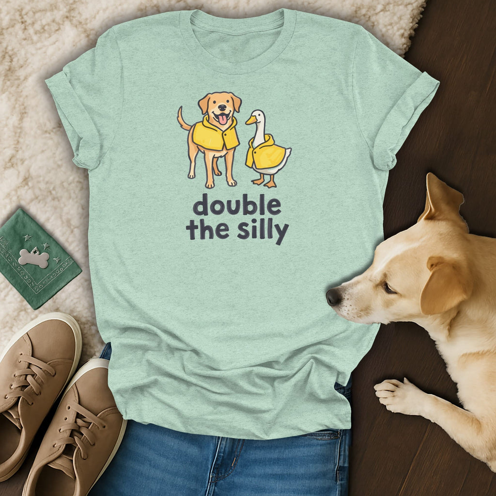 Mint green t-shirt with cartoon dog and duck wearing yellow raincoats and text "double the silly".