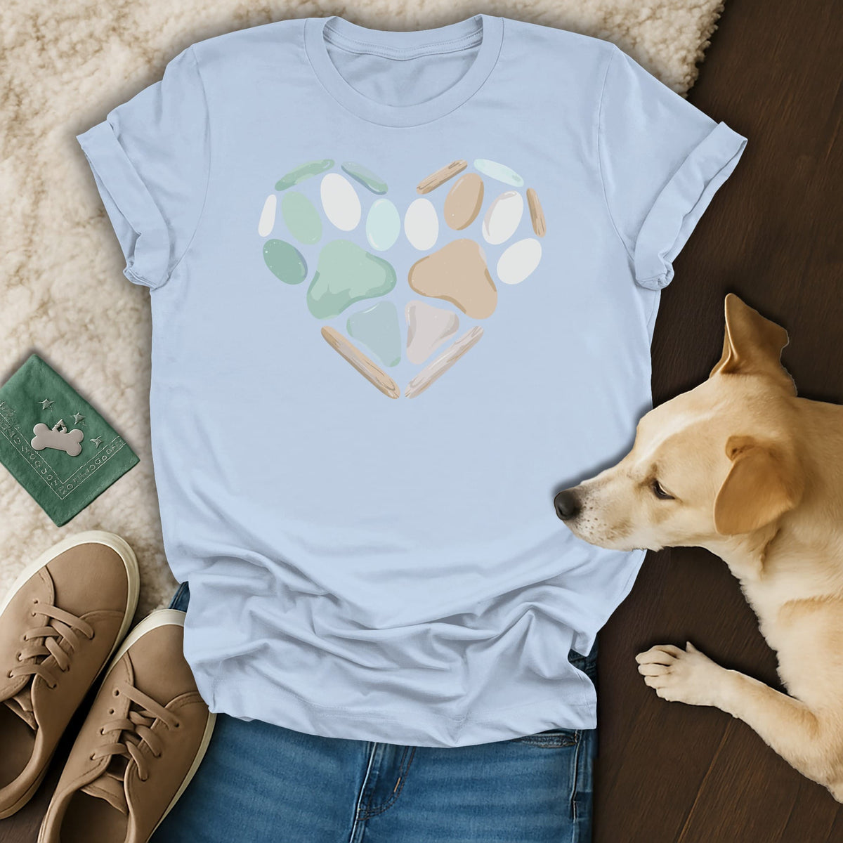 Light blue t-shirt with a heart made of paw prints and driftwood.