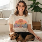 Woman in cream t-shirt with "paws, pose, repeat" yoga dogs design.