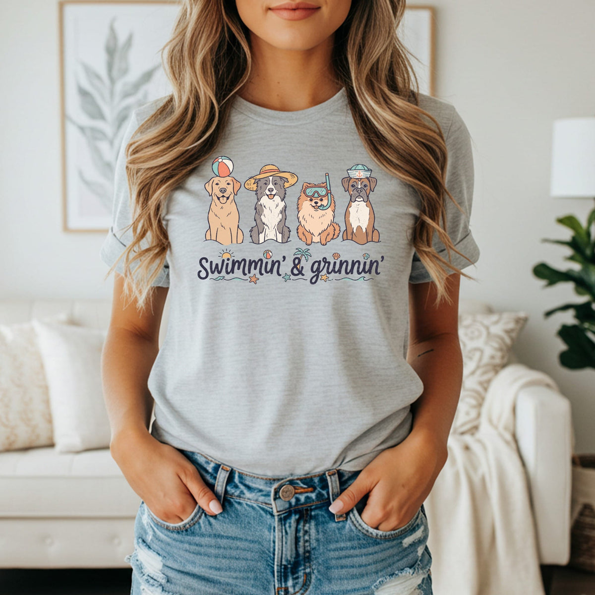 T-shirt with four dogs in swim attire and "Swimmin' & Grinnin'" text.