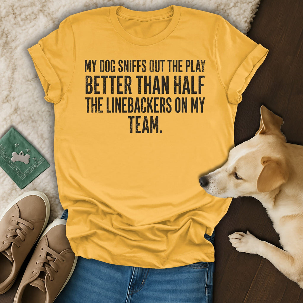 Yellow t-shirt with text about a dog's football play-sniffing ability.