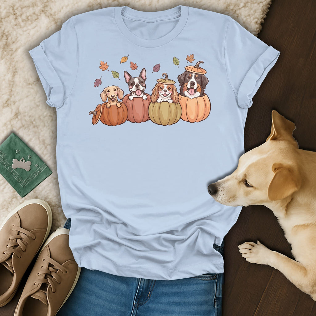 Light blue t-shirt with a graphic of four dogs in pumpkins and falling leaves.