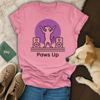 Pink t-shirt with "Paws Up" text, dancing dog outline, and speakers.