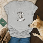 Light grey t-shirt with a drawing of a dachshund on a robot vacuum and text "HERE FOR THE FUR-NANIGANS".