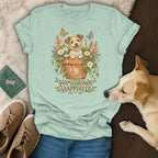 Light green t-shirt with a graphic of a puppy in a flowerpot and the text Homegrown Happiness.