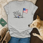 Dog wearing bandana rolls near American flag with 1776-2026 text.