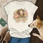 A white t-shirt featuring a vintage illustration of a senior dog surrounded by flowers and the text FEWER YEARS MORE LOVE.