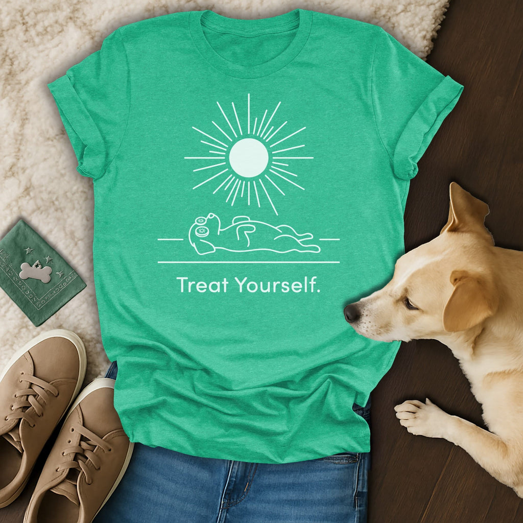 Green t-shirt with sun graphic and "Treat Yourself" text, lying next to a dog.