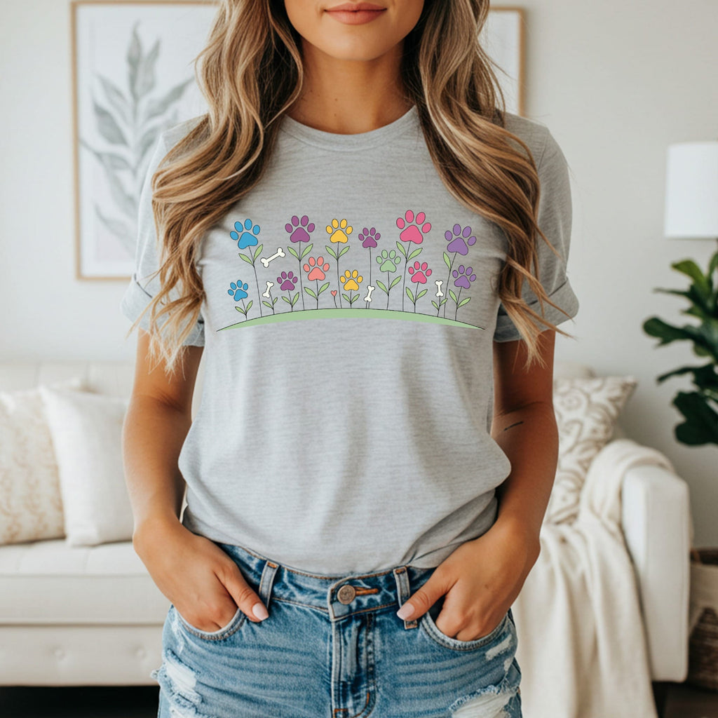Gray t-shirt with colorful paw print flowers and dog bones.