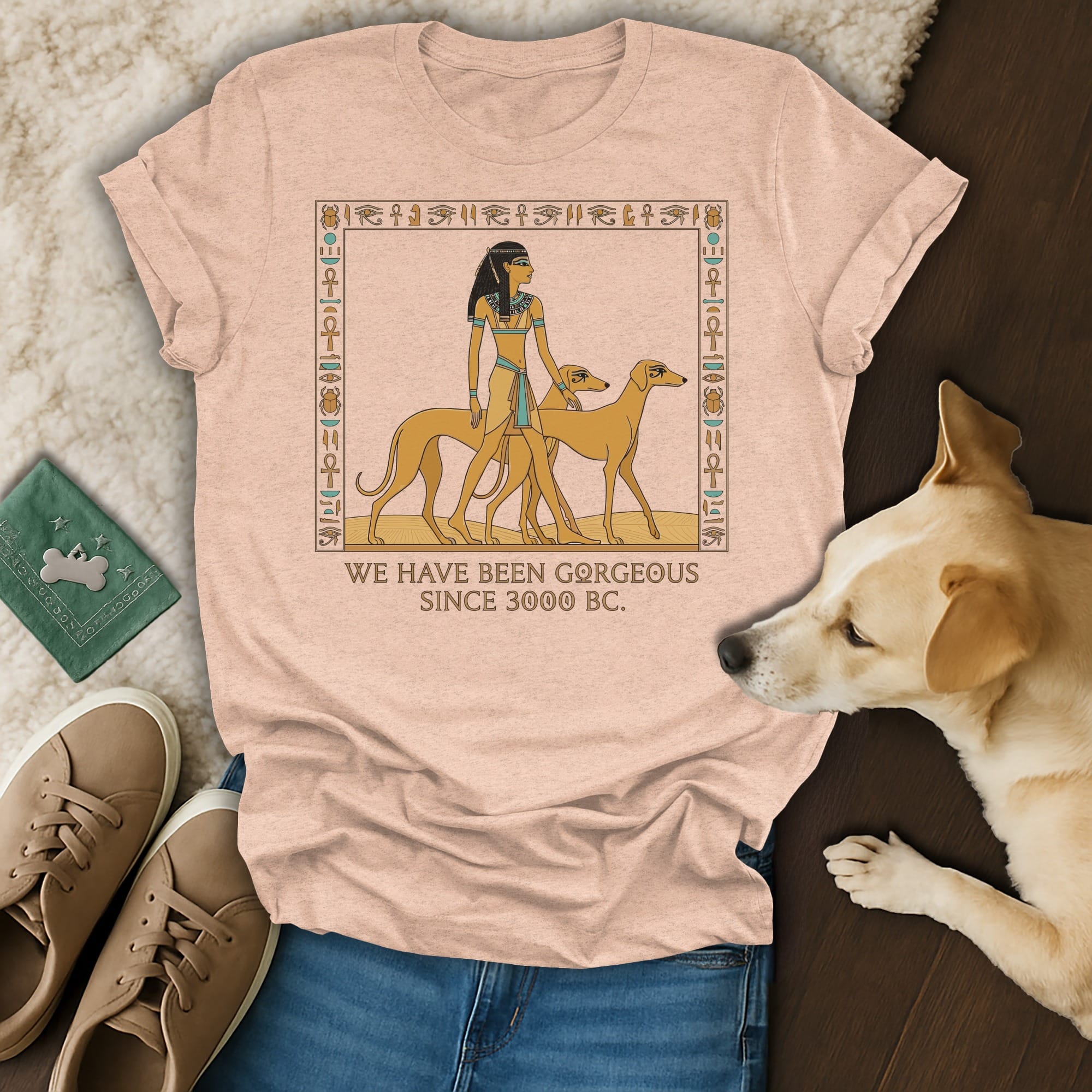 T-shirt with Egyptian-themed art of a woman and two dogs, text reads "WE HAVE BEEN GORGEOUS SINCE 3000 BC."