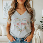 Grey t-shirt with a heart-shaped graphic of dog-related icons and the text "DOG MOM".