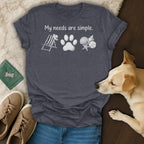 Dark grey t-shirt with "My needs are simple" text and beach icons.
