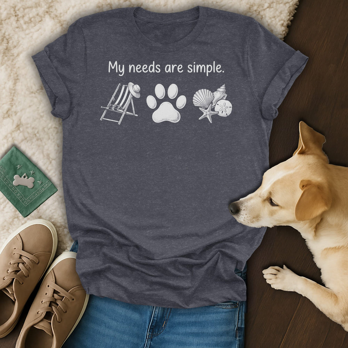 Dark grey t-shirt with "My needs are simple" text and beach icons.
