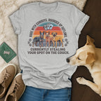 Gray t-shirt with cowboys, dogs, and text about stealing a couch spot.