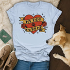 Light blue t-shirt with a red heart tattoo design reading "MY DOG OWNS ME".