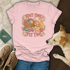 A pink t-shirt displaying a vintage graphic of a puppy, yarn, and flowers with text reading Knit One Pet Two.